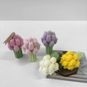 Detailed close-up of handmade tulip flower candles in pink, purple, white and yellow colors