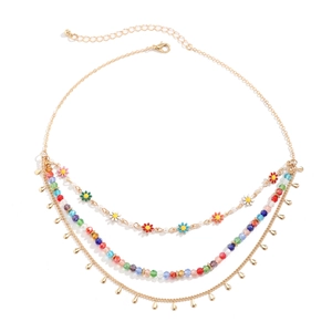 Macro view of multi-layer colorful beaded necklace with floral pendants and gold chain