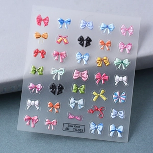 Macro view of 5D bow knot nail art stickers with textured patterns and embossed details
