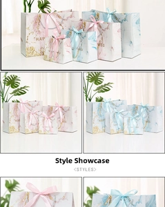 Macro detail of marble gift bags with gold Happy Times text and soft satin ribbon bows