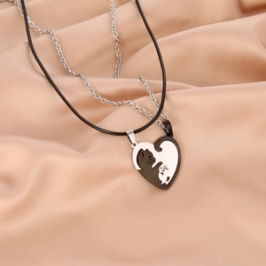 Cat couple necklaces with heart pendants in stainless steel on pink silk background