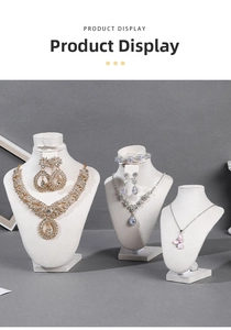 Three jewelry display busts featuring gold necklaces, silver gemstone sets and pink pendants