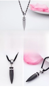 Detailed macro view of bullet pendant necklace with crystal ring and stainless steel chain