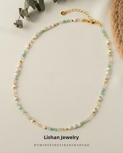 Detail of colorful beads with gold spacers, lobster clasp and extension chain