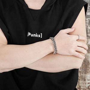Detail shot of silver thick chain bracelet and ring set in bold industrial street style