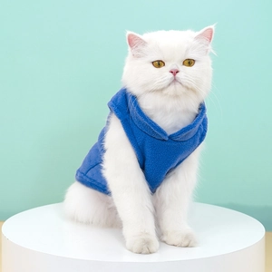 Blue soft polar fleece pet vest worn by a white cat on a mint green background