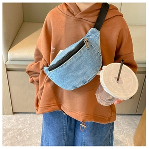Detail shot of blue denim crossbody bag for kids featuring adjustable black strap and zipper