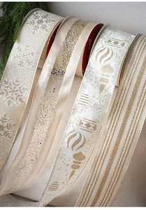 Detail of Christmas velvet ribbons with gold stamped festive patterns for gift wrapping