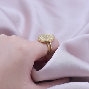 Detailed view of a gold sunray coin ring with a double-layered adjustable band on model