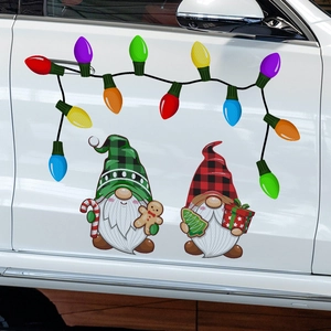 Detail of Christmas gnomes and colorful bulb magnets on a white car door surface