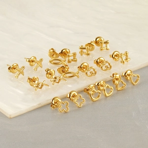 Golden stainless steel stud earring set with heart, cloud and clover shapes on marble