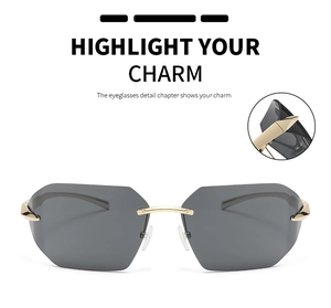Detail of rimless grey lenses and golden metal bridge on stylish oversized sunglasses