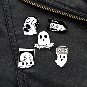 Set of five ghost enamel pins pinned on a black leather jacket for Halloween styling