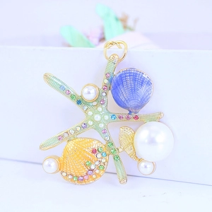 Starfish and shell keychain with pearls and colorful crystals on gold metal base