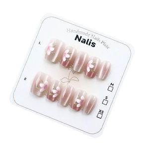 Cat eye press-on nails with pink floral hand-painted designs on white display card