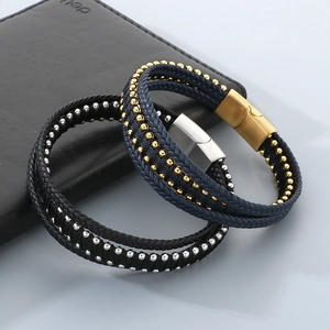 Macro detail of multi-layer leather bracelets with magnetic clasps and steel beads