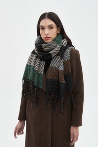 Detail of multi-color striped checkered scarf with fringe on herringbone wool coat