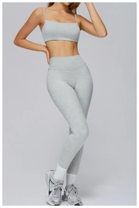 Close-up of the light gray brushed fabric texture on the yoga top and leggings