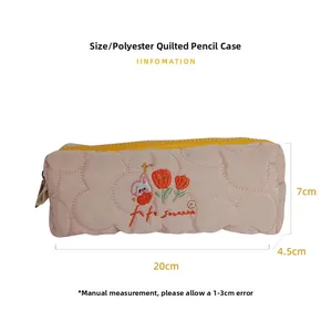 Detail view of pink quilted tulip pencil case with cute rabbit embroidery and zip closure