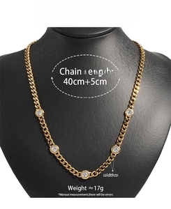 Detail of 5mm gold stainless steel Cuban chain necklace with four round-cut zircon stones