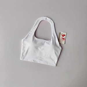 Detailed view of white halter sports bra with Lycra fiber tag for athletic support