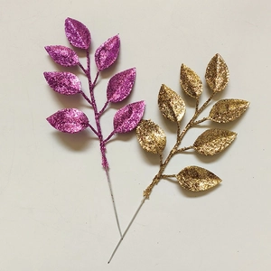Glittery artificial Christmas leaves in purple and gold for DIY wreaths and tree decoration