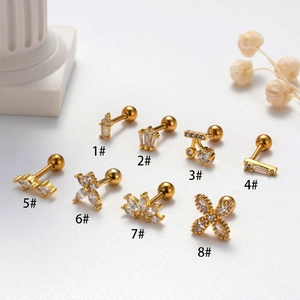 Eight gold cartilage studs with cubic zirconia in crown and flower shapes with screw balls