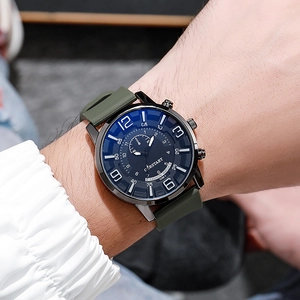 Close-up of military green silicone strap watch with black sport dial on wrist