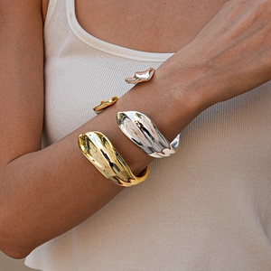 Irregular organic-shaped open bangles in polished gold and silver metallic finishes
