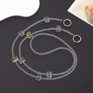 Detail of transparent bead phone chain with colorful resin gummy bear charms and metal rings