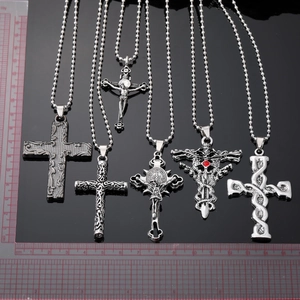 Selection of antique silver cross pendants with intricate reliefs and bead chains
