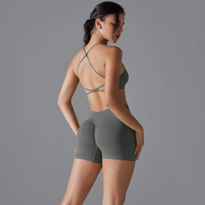 Close-up of olive green seamless yoga set featuring scrunch butt shorts and cross back bra