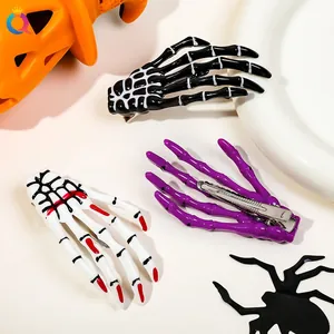 Skeleton hand hair clips in black, white with red nails, and purple for Halloween decor