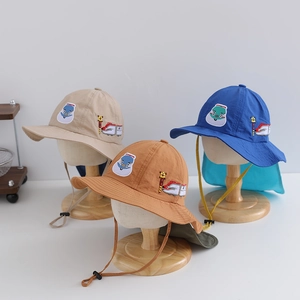 Detail view of children's sun hats with neck flaps and cartoon train embroidery