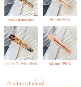 Detailed close-up of acetate hair clips in beige tortoise, pearl white, brown, and soft pink