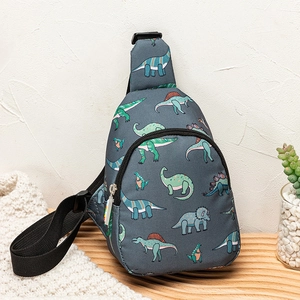 Detail of a kids dinosaur crossbody bag on a wooden stand with a soft background