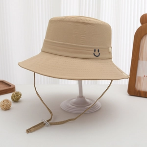 Detail of khaki polyester bucket hat showing smiley face embroidery and adjustable chin strap
