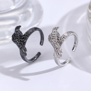 Macro detail of gothic raven rings showing intricate feather textures in black and silver