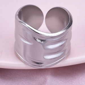 Macro shot of 304 stainless steel ring with irregular hammered wavy texture and silver finish