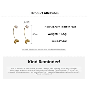 Detailed view of gold curved earrings with faux pearls and metal floral textures