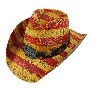 Detail of western straw hat featuring eagle metal emblem and star patterned band