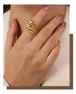 Detail of multi-layer wide gold ring with a five-row wrap design on model's hand