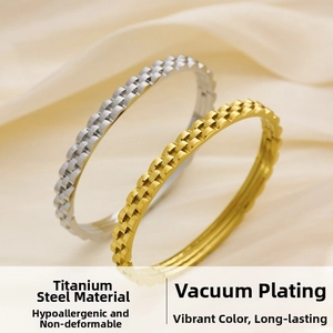 Detail of 18k gold plated titanium steel bangles with gear link chain texture