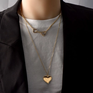 Double-layered gold heart pendant necklace for women featuring hollow and solid heart charms