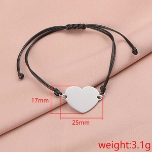 Detail view of heart-shaped stainless steel pendant on black cord showing 25mm dimensions