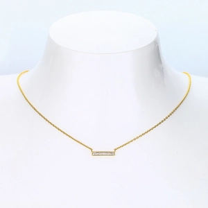 Detailed shot of a gold 925 silver necklace with a sparkling zircon bar pendant