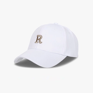 Close-up of white baseball cap with pineapple texture and gold R letter embroidery