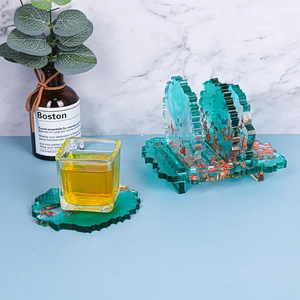 Close-up of emerald resin irregular coasters with gold foil and storage stand set