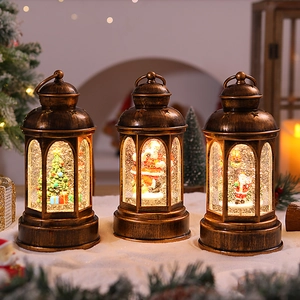 Three bronze Christmas lanterns with LED glowing snow globes and Santa Claus miniature scenes