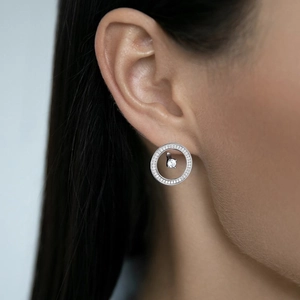 Detailed close-up of a 925 sterling silver hoop earring featuring zircon stone on a model